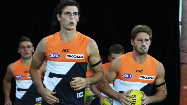 Phil Davis and Callan Ward lead out the Giants in the club’s first match.