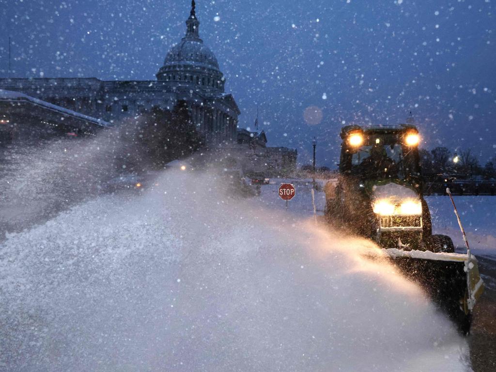 Crews work before dawn to clear snow East Front Plaza of the US Capitol as a winter storm slams into the nation's capital. Picture: CHIP SOMODEVILLA / Getty Images via AFP