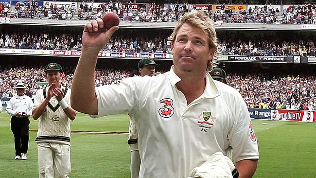 Shane Warne holds the Kookaburra aloft to celebrate taking five wickets against England in the 2006 Boxing Day Test at the MCG.