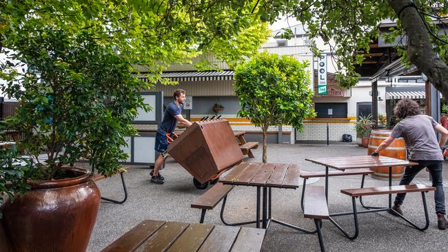 Notting Hill Hotel staff clear out outdoor furniture. Picture: Asanka Ratnayake/Getty Images