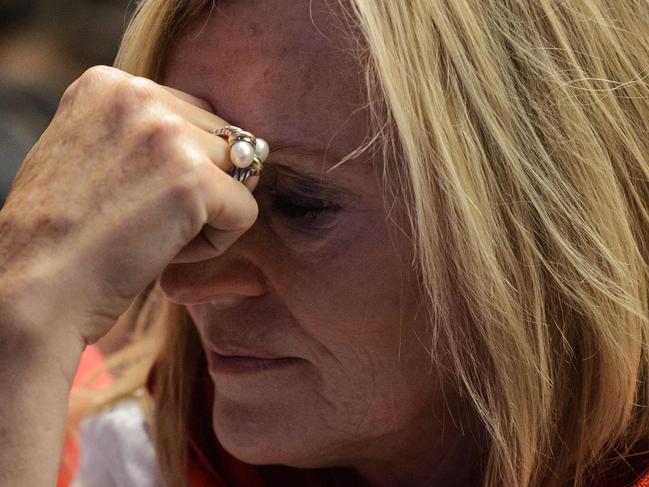 A supporter of Hillary Clinton reacts as she watches live coverage of the US elections at an event organised by the American Chamber of Commerce in Hong Kong on November 9, 2016. Share markets collapsed and the dollar tumbled against the yen and the euro as Donald Trump looked on course to win the race for the White House, in a stunning upset with major implications for the world economy. / AFP PHOTO / ANTHONY WALLACE