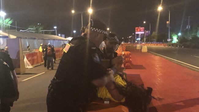 Aboriginal protesters are arrested by police at the Commonwealth Games opening ceremony. Picture: Britt Ramsey