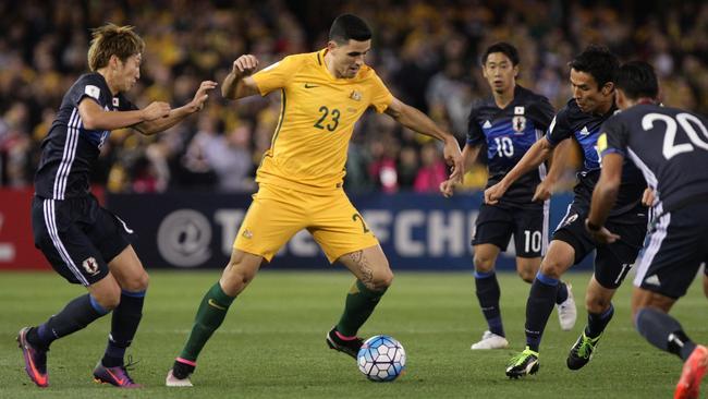 Tomas Rogic surrounded by four Japanese players. AAP Image/Stefan Postles.