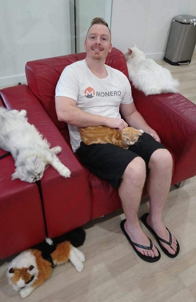 A Gold Coast father-to-be has been identified as the victim of a fatal e-scooter crash in Nerang on Friday. Stuart “Stu” Jackson, with his cat “kinky,” named after the kink in his tail. Photo: Supplied.