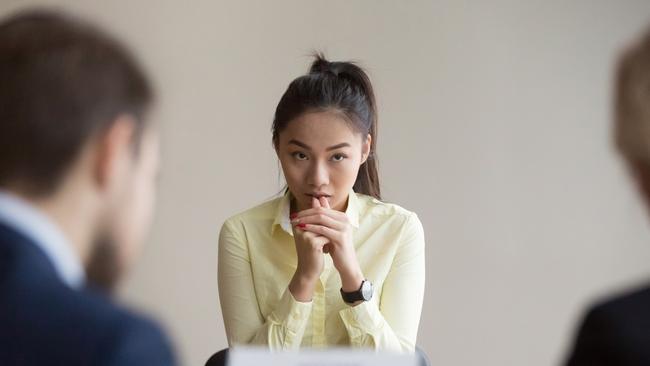 GCB PICTURE - Nervous young Asian job applicant wait for recruiters question during interview in office, worried intern or trainee feel stressed applying for open position, meeting with hr managers. Hiring concept