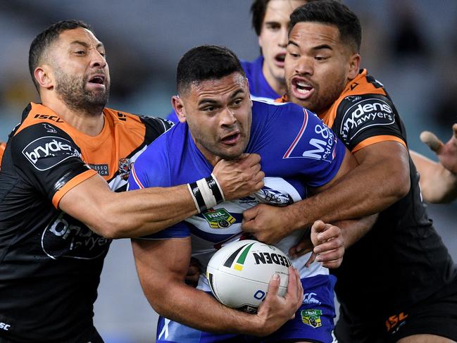 Rhyse Martin of the Bulldogs is tackled by Benji Marshall (left) and Esan Marsters of the Tigers during the Round 20 NRL match between the Canterbury-Bankstown Bulldogs and the Wests Tigers at ANZ Stadium in Sydney, Friday, July 27, 2018. (AAP Image/Dan Himbrechts) NO ARCHIVING, EDITORIAL USE ONLY