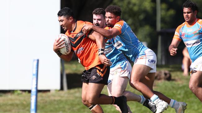 Tully’s Fabien Tauli takes the Pride defenders with him in the Round 2 match of the Lightning Challenge between the Northern Pride Reef Kings and the Tully Tigers, held at Stan Williams Park. PICTURE: BRENDAN RADKE