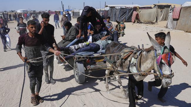 A man shot at an aid distribution centre run by a US-backed organisation approved by Israel in Khan Yunis, southern Gaza, is taken for treatment. Picture: AP