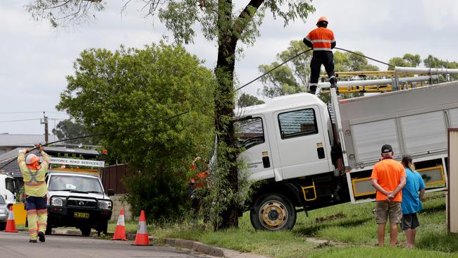 Workers from Endeavour Energy repairing the fallen powerline at Plumpton. Picture: Jonathan Ng