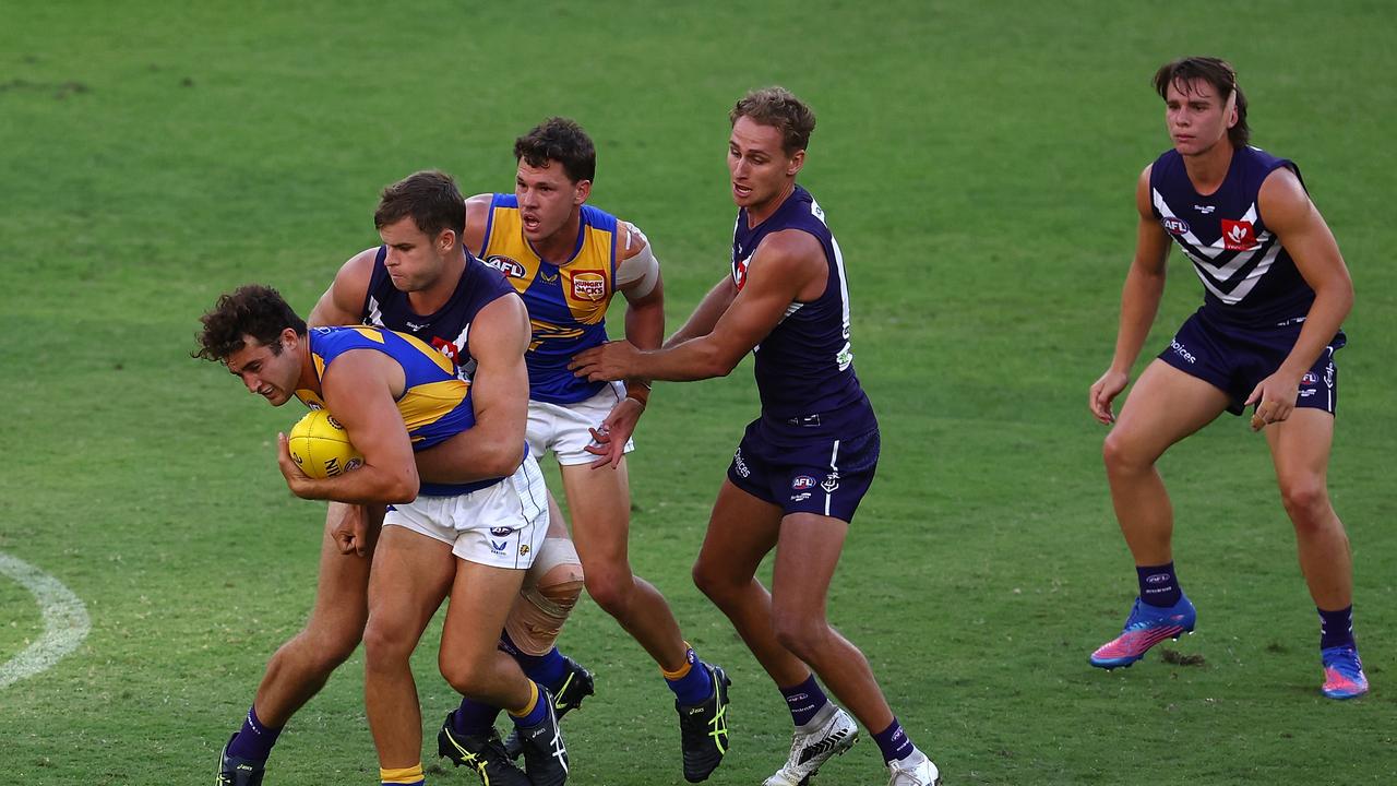 Tom Joyce is wrapped up by Dockers ruckman Sean Darcy.