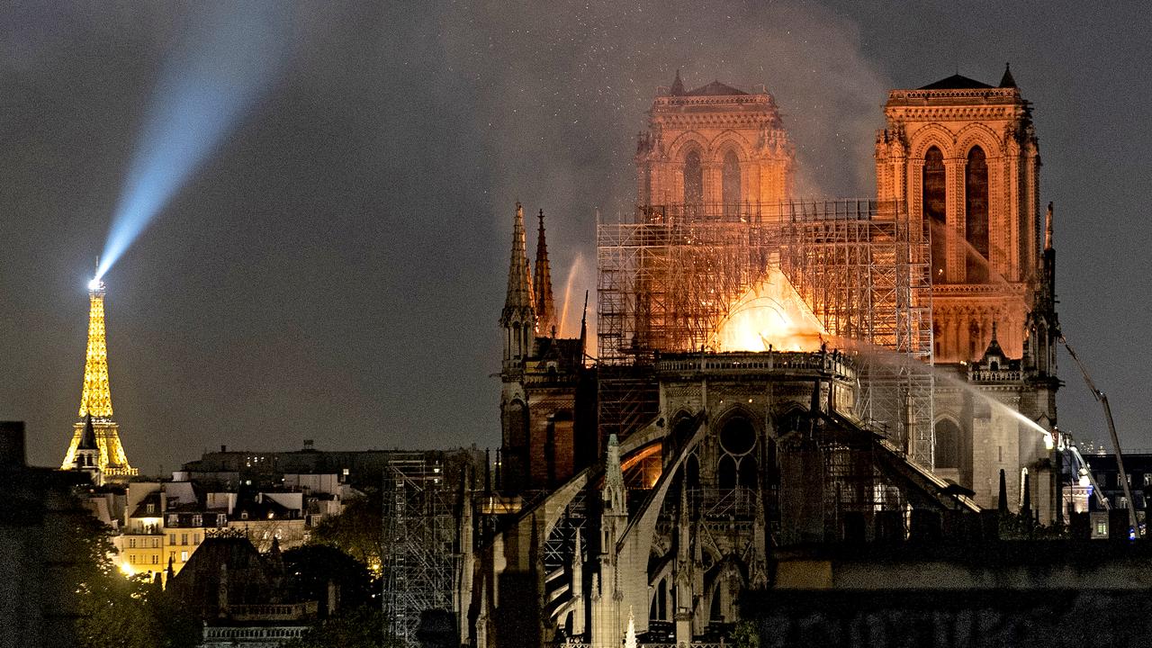 PARIS, FRANCE - APRIL 15: (EDITOR'S NOTE: Re-transmission with alternate crop) Flames and smoke are seen billowing from the roof at Notre-Dame Cathedral on April 15, 2019 in Paris, France. A fire broke out on Monday afternoon and quickly spread across the building, collapsing the spire. The cause is yet unknown but officials said it was possibly linked to ongoing renovation work. (Photo by Veronique de Viguerie/Getty Images)