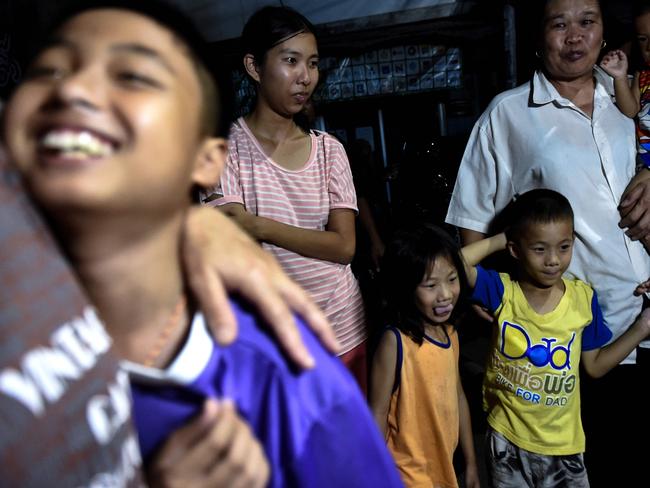 Friends and family are overjoyed as they wait outside the hospital. Picture: AFP/Lillian Suwanrumpah.