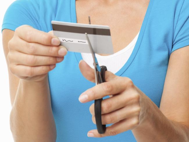 A woman cutting up her credit card. Picture: iStock.