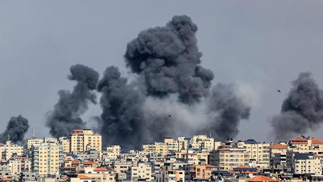 Smoke rises over Gaza City on October 7 during an Israeli air strike. Palestinian militants have begun a "war" against Israel, the country's defence minister said after a barrage of rockets were fired and fighters from the Palestinian enclave infiltrated Israel.