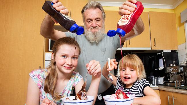 Pakenham grandfather Ian Rowed 71 sneaks junk food treats into the diet of his grandchildren, Savannah, 11 and Sophia, 5. Picture: Mark Stewart