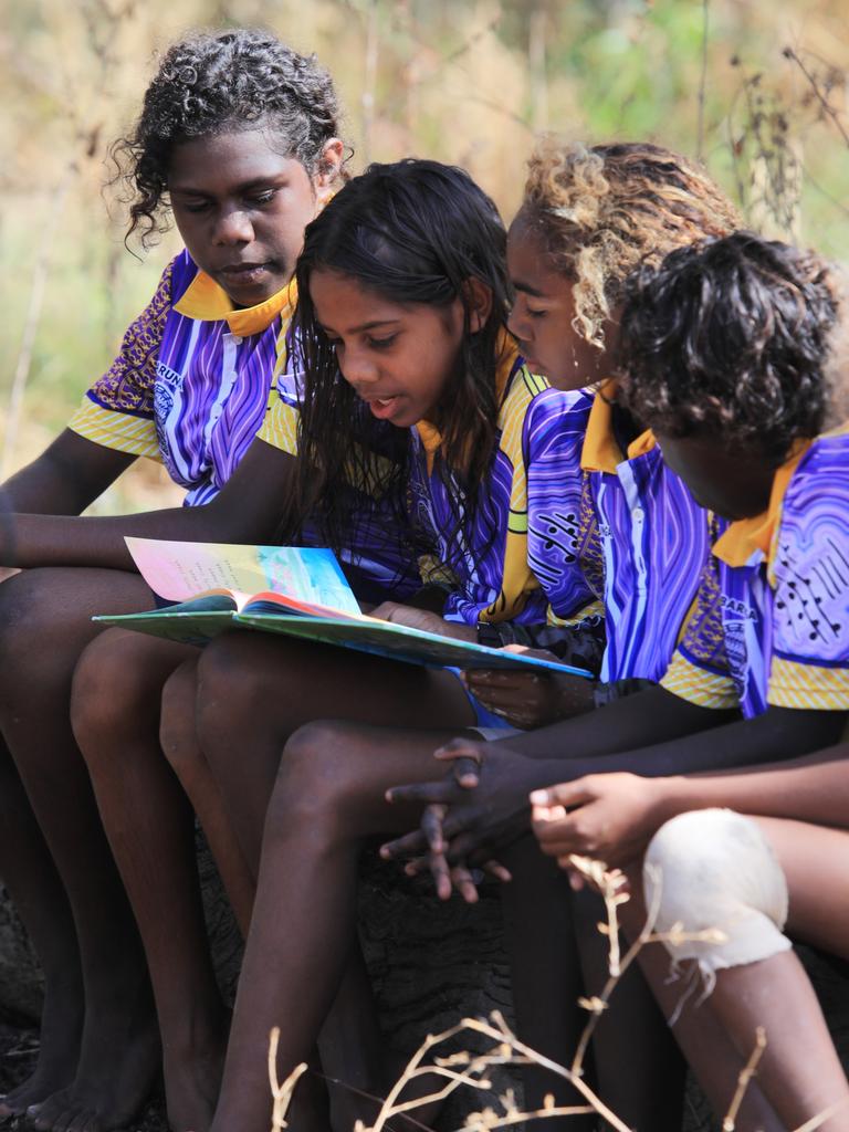 Shordi Krik is a collaboration between ILF Ambassador Justine Clarke and kids from Barunga in the NT, pictured reading their book. Picture: supplied/Indigenous Literacy Foundation