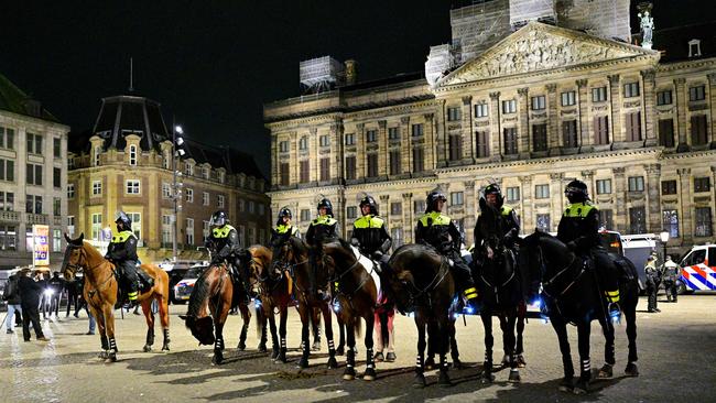 Police officers on horses secure during an unauthorised pro-Palestinian demonstration on Dam Square in Amsterdam.