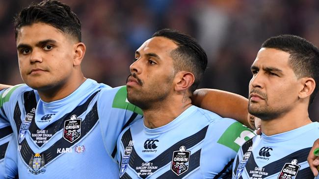 Blues players Latrell Mitchell (left) Josh Addo-Carr (centre) and Cody Walker remain tight-lipped during the national anthem before Game 1 of last season’s Origin series. Picture: Dave Hunt/AAP