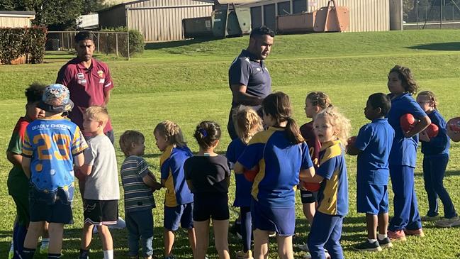 Keidean Coleman (left) of the Brisbane Lions with kids at the Auskick Murri Carnival program in Toowoomba.