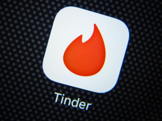FE01RA Tinder dating app logo on an iPhone smart phone