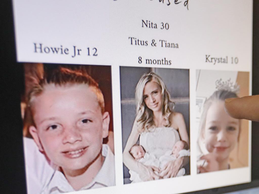 A relative points to the funeral book for Ms Miller and her family. Picture: Rick Bowmer/AP