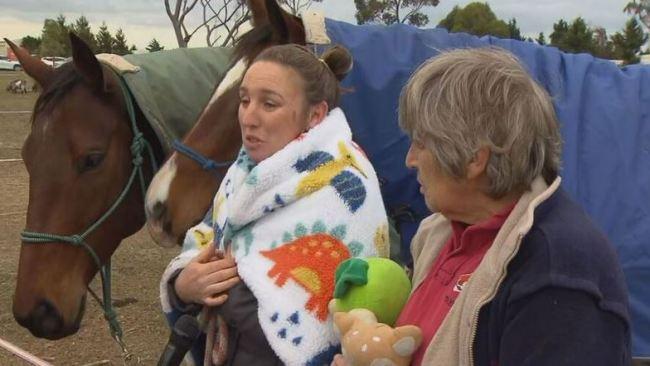 Karin speaks to the media supported by her mum and her horses. Picture: 9News