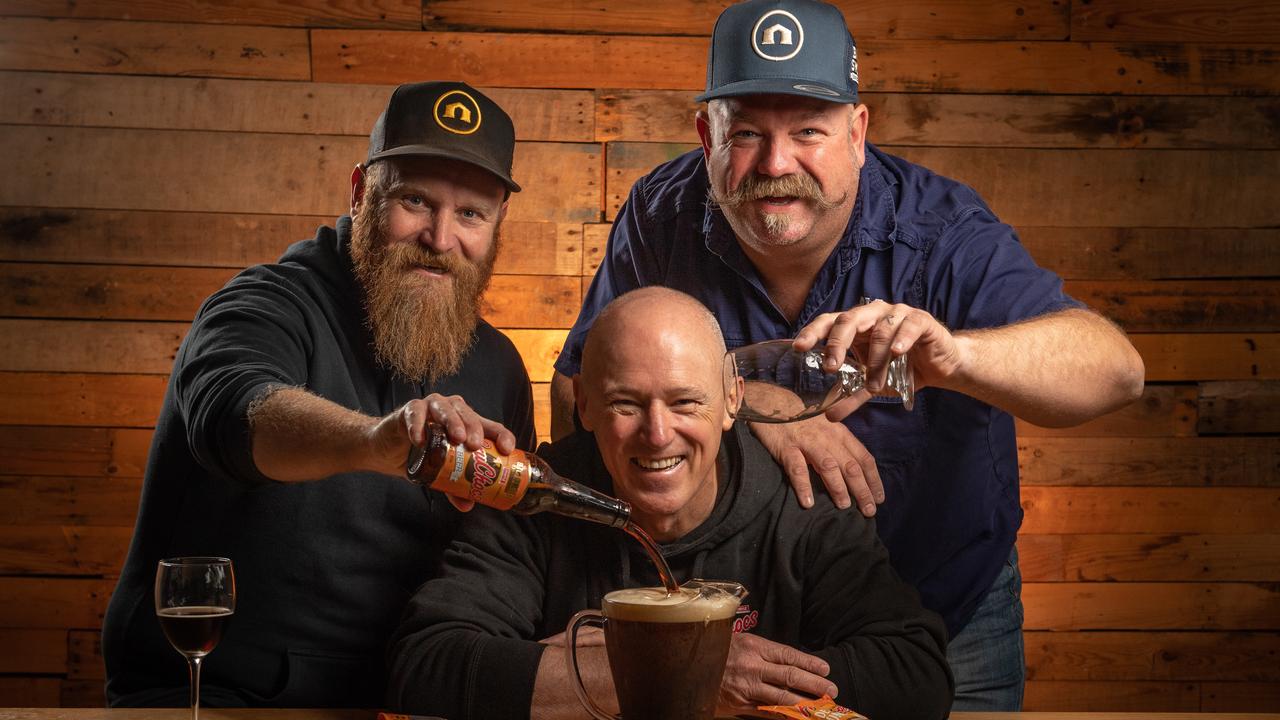 Robern Menz CEO Phil Sims (centre) with Big Shed Brewing owners Craig Basford and Jason Harris with the BruChoc dark stout they’ve made for FruChoc Appreciation Day. Picture: Brad Fleet