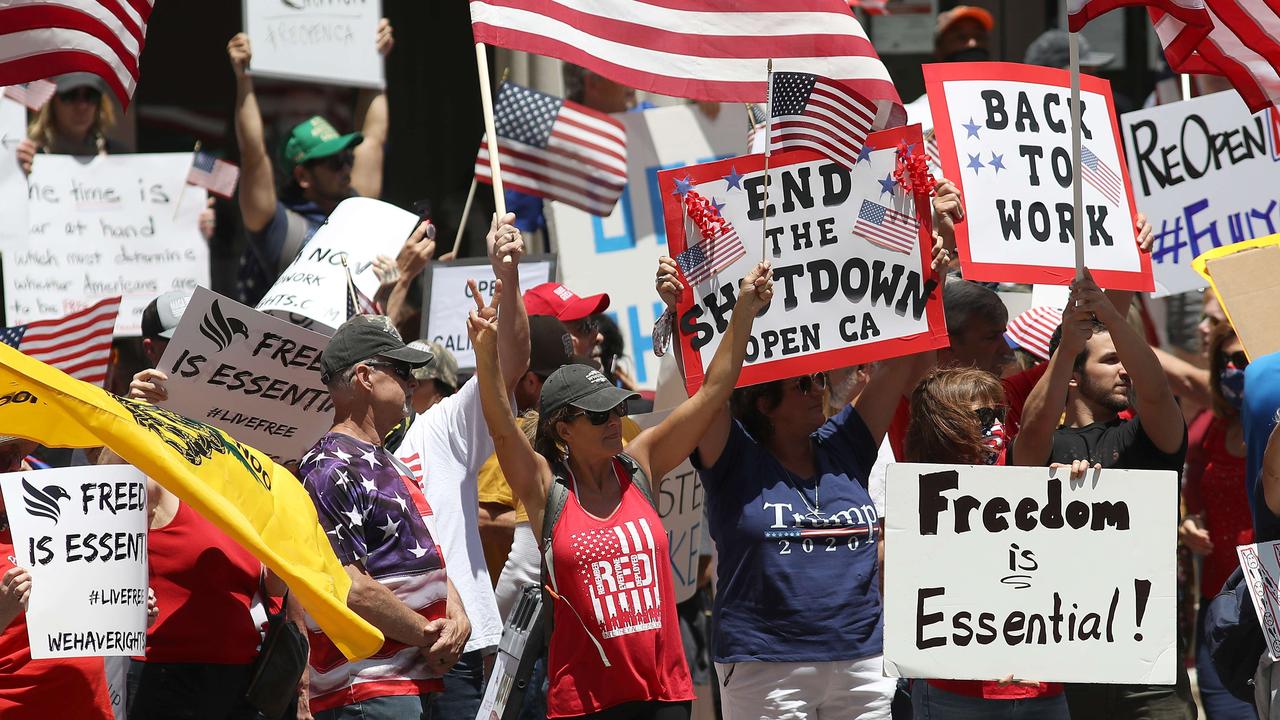 Activists hold signs and protest the lockdown in San Diego, California on Friday. The protesters demands included opening small businesses, churches as well as support for President Trump. Picture: Sean M. Haffey/Getty Images/AFP