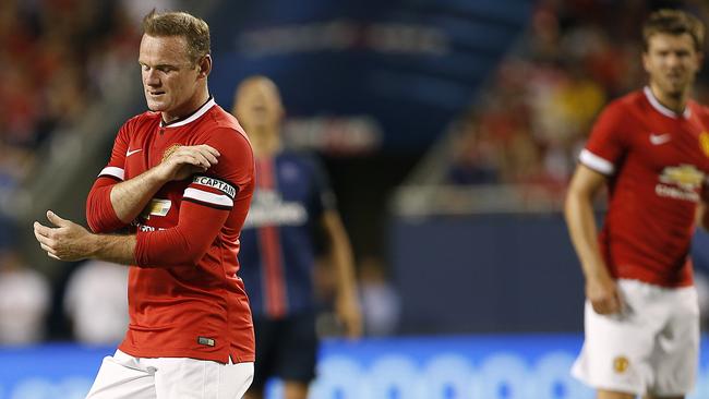 Manchester United forward Wayne Rooney (L) reacts after missing a goal against Paris Saint-Germain during the second half of their International Champions Cup soccer game at Soldier Field in in Chicago, Illinois on July 29, 2015. AFP PHOTO/ JOSHUA LOTT