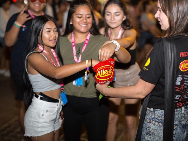 Red Frogs volunteers handing out their trademark red frog lollies to Schoolies on the Gold Coast. Picture: Micah Coto