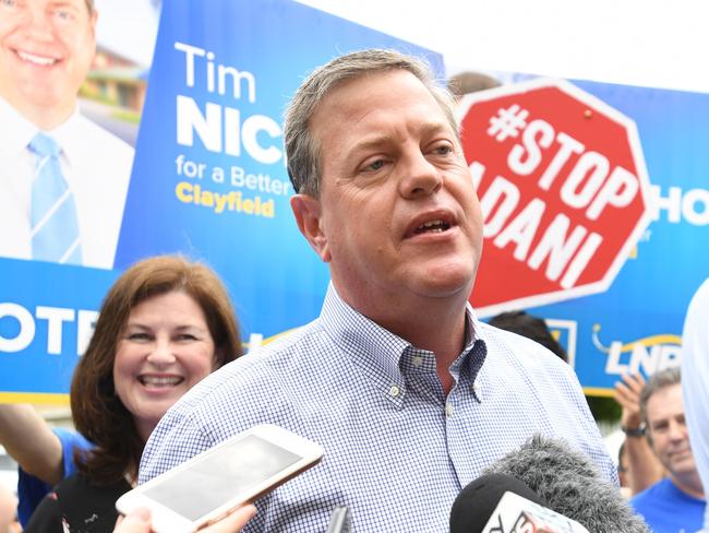 Queensland Opposition Leader Tim Nicholls is surrounded by Anti-Adani protesters as he arrives to vote at St John Anglican Church on Saturday. Picture: Tracey Nearmy/AAP