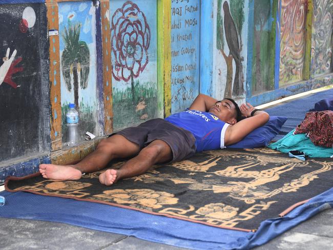 An Asylum seeker sleeps on his bed in the Lombrum detention centre. Picture: Brian Cassey