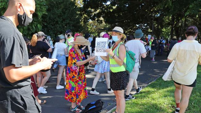 Organisers encouraged attendees to sign in with a QR code and sanitise. Picture: Richard Dobson