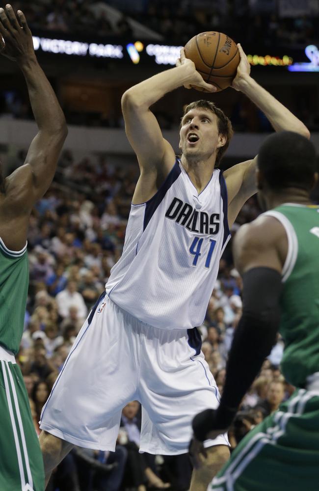 Mavericks forward Dirk Nowitzki prepares to shoot in front of two Celtics defenders.