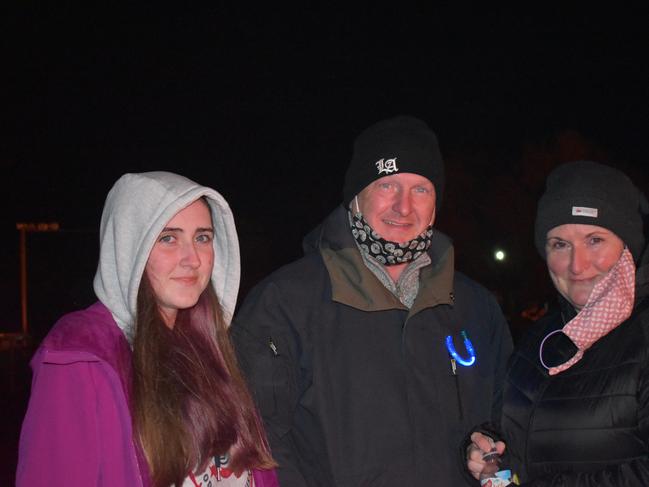 Josie, Jim, and Siobhan Madden soaking up the fireside warmth at the 2021 Killarney Bonfire Night.