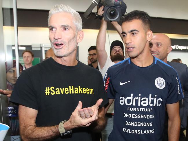 MELBOURNE, AUSTRALIA - FEBRUARY 12:  Refugee Bahraini footballer Hakeem al-Araibi walks with Craig Foster, former Australian football captain and commentator as he arrives at Melbourne Airport on February 12, 2019 in Melbourne, Australia. Bahraini refugee Hakeen al-Araibi was detained in November when he arrived in Thailand for his honeymoon, spending more than two months in jail while fighting extradition to Bahrain. Al-Araibi fled his home country in 2014 and was granted refugee status in Australia on the grounds he was persecuted and tortured in the Arabian Gulf state for participating in pro-democracy rallies. (Photo by Scott Barbour/Getty Images)