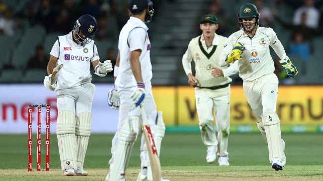 Tim Paine and Australia celebrate Virat Kohli's dismissal.