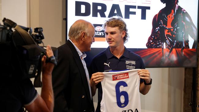 Malcolm Blight handing Jason Horne-Francis his North Melbourne guernsey on draft night, 2021. Picture: James Elsby/AFL Photos via Getty Images