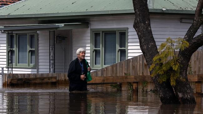 A man leaves his flood-ravaged Maribyrnong home. Picture: Getty Images