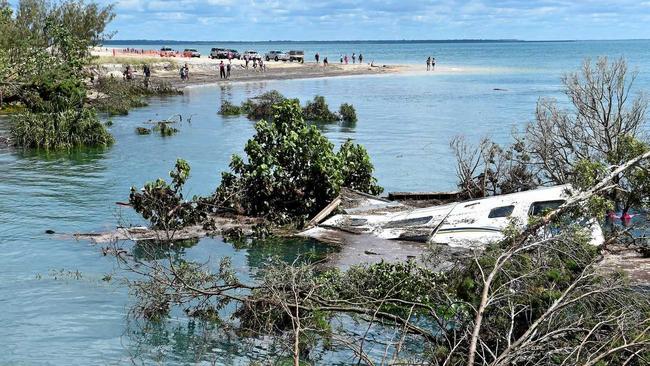 UNDETERRED: The large sink hole that swallowed camp sites and property at Inskip Point last year, is not enough to deter Cooloola Coast fans Jenny and Dieter Gass. Picture: Che Chapman