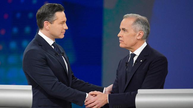 Conservative Leader Pierre Poilievre (L) and Canadian Prime Minister and Liberal Party chief Mark Carney shake hands following the English Federal Leaders Debate. Picture: AFP.