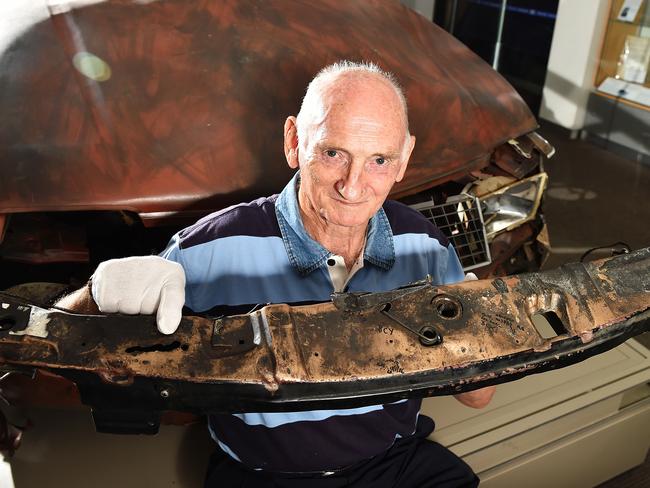 Former detective Arthur Adams holding the radiator support panel from the car the Russel Street bomb was in. He is pointing to where the chassis number on this was drilled off in a very unique way. Picture: Ellen Smith