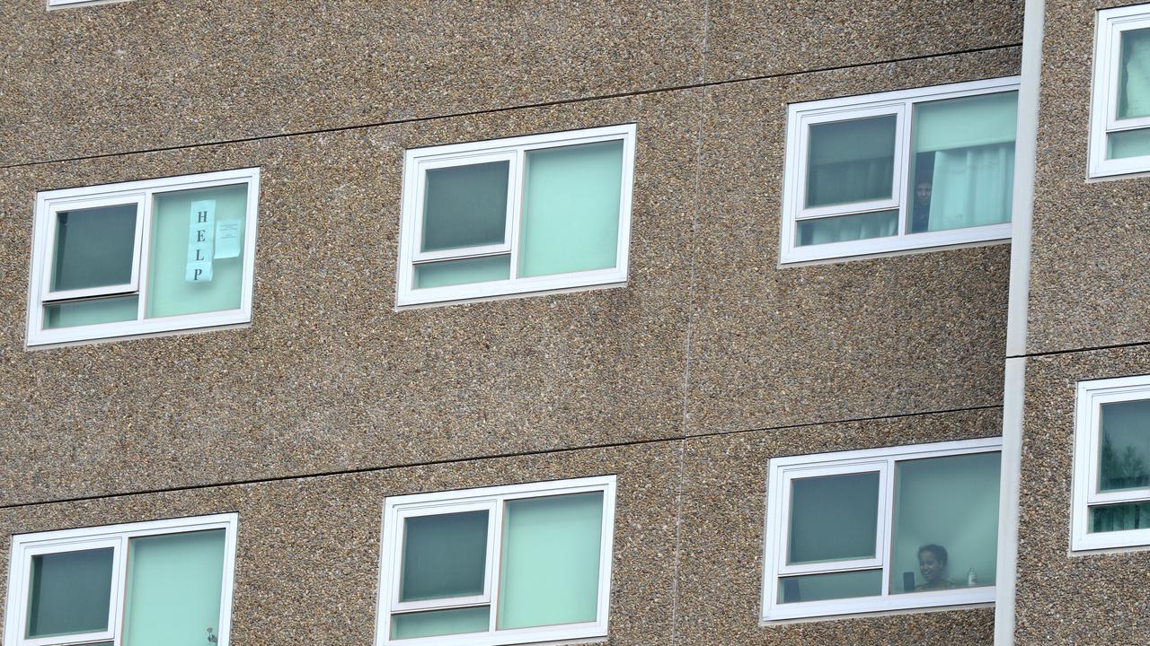 Residents look out from the North Melbourne public housing estate. Picture: NCA NewsWire / Andrew Henshaw