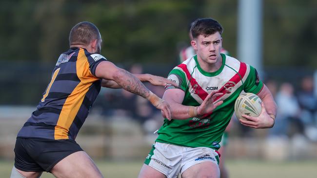 Taine Woodford tries to allude Eli Roberts.Picture: Adam Wrightson Photography. Souths Juniors Rugby League - A Grade.Round 14 - A GradeSouth Eastern Seagulls vs Matraville Tigers.Pioneer Park, Malabar, 2:20pm.11 August 2024.