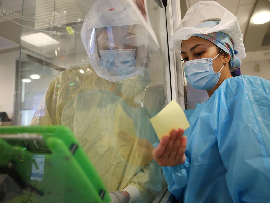 Nurses check over notes on a COVID patient. Picture: AFP