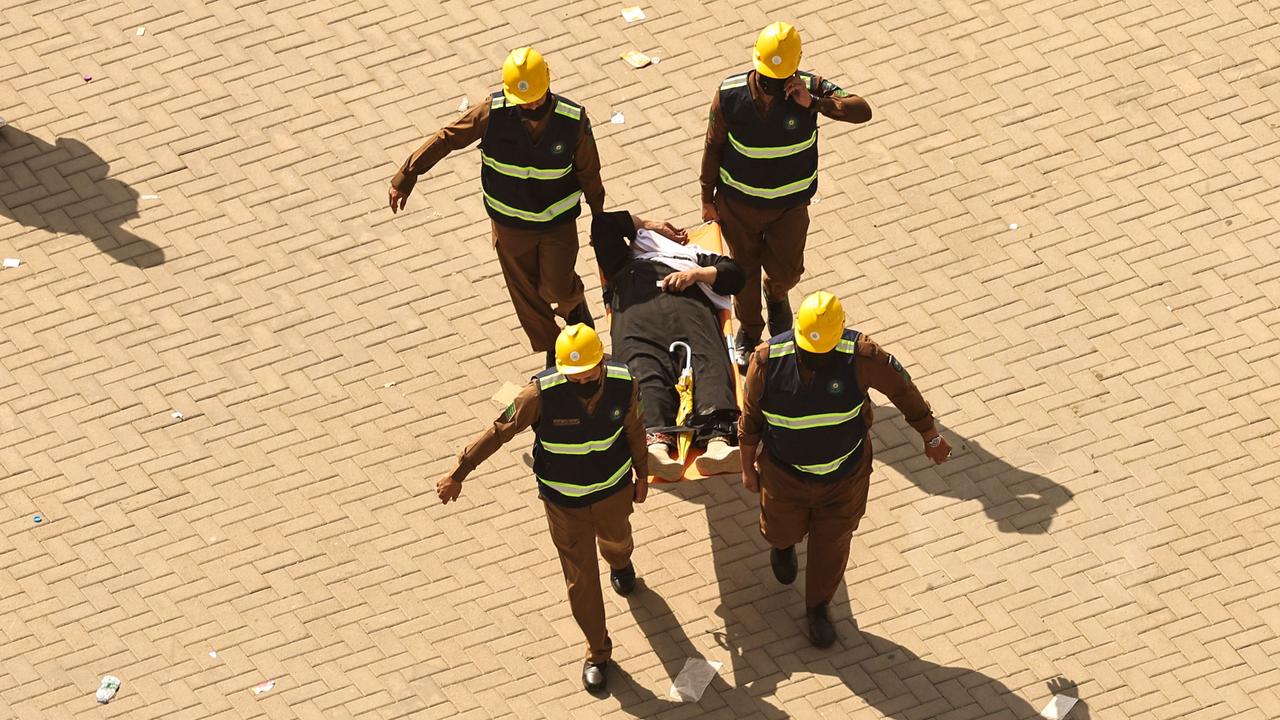 Rescuers carry away a man on a stretcher as Muslim pilgrims arrive to perform the symbolic 'stoning of the devil' ritual in Mina on June 16. Picture: Fadel Senna / AFP