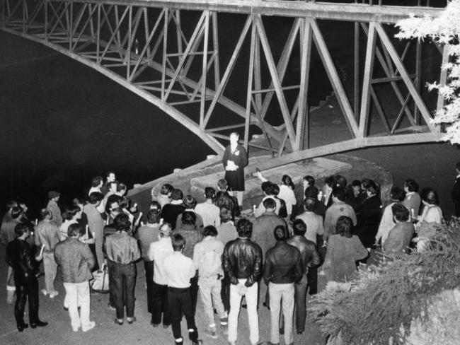 Members of Adelaide's gay community mourn mark the 10th anniversary of the death of Dr George Duncan beneath the Adelaide University footbridge.