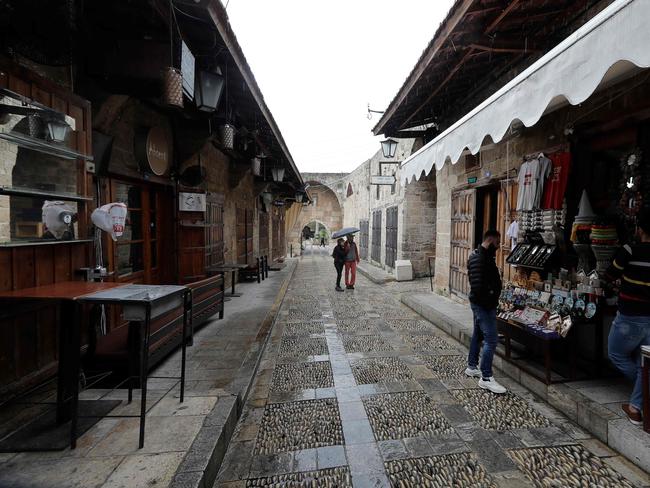 A shopkeeper waits for customers, in one of the streets of Lebanon's coastal historical city of Byblos, usually bustling with visitors, after shops and restaurants. Picture: AFP