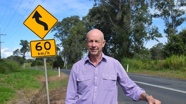 Councillor Bob Fredman stands next to the Mary Valley Rd.