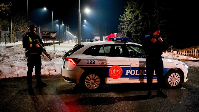 Police officers stand guard at a check point on the outskirts of Cetinje after a gunman killed several people in the nearby village of Bajice. Picture: Savo Prelevic/AFP